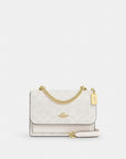 Mini Klare Crossbody Bag In Signature Canvas (Gold/White/Chalk)