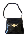 s GCCI saddle bag in black leather with muted gold hardware, an expandable bottom, wide shoulder strap, and burgundy leather lining
