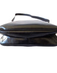 s GCCI saddle bag in black leather with muted gold hardware, an expandable bottom, wide shoulder strap, and burgundy leather lining