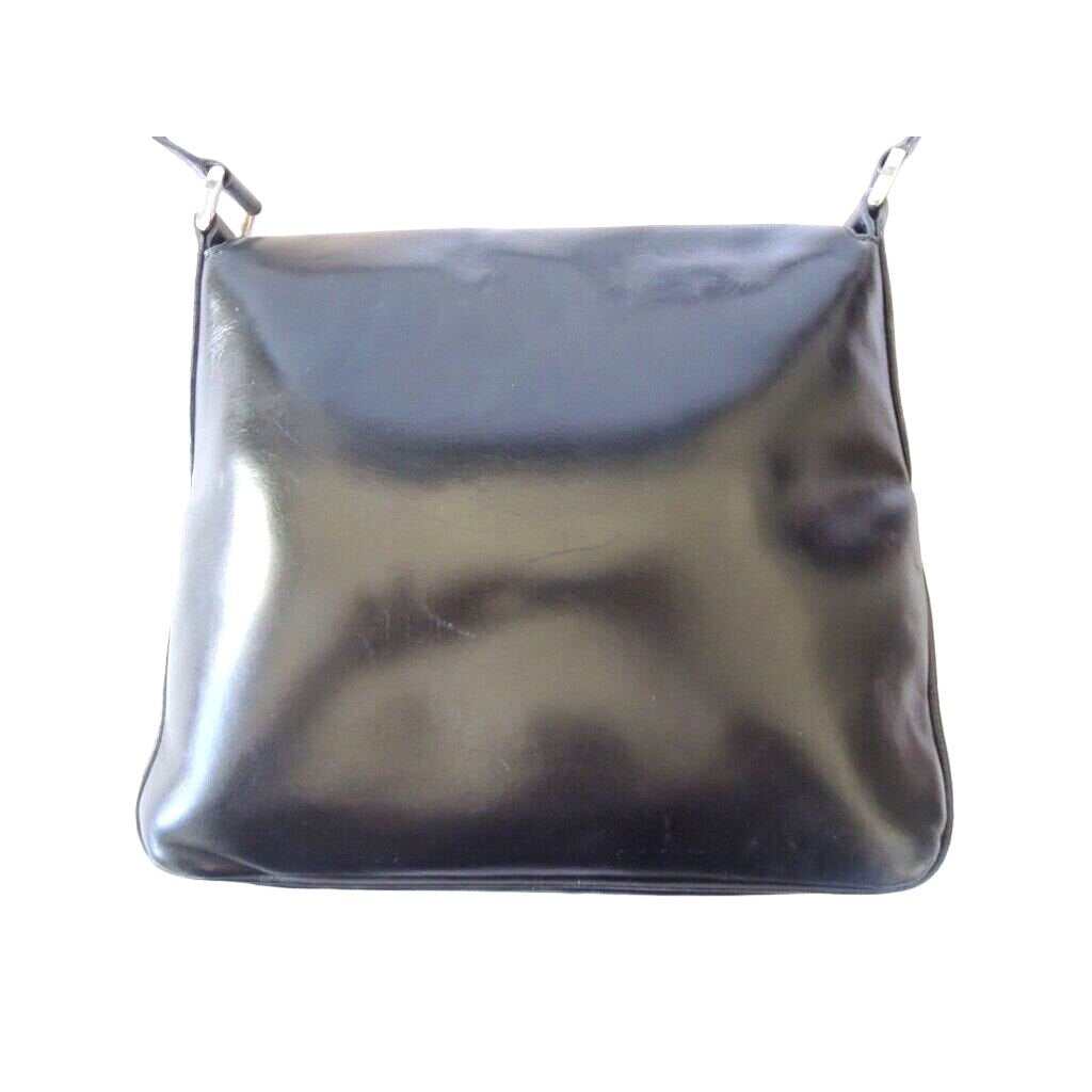 s GCCI saddle bag in black leather with muted gold hardware, an expandable bottom, wide shoulder strap, and burgundy leather lining