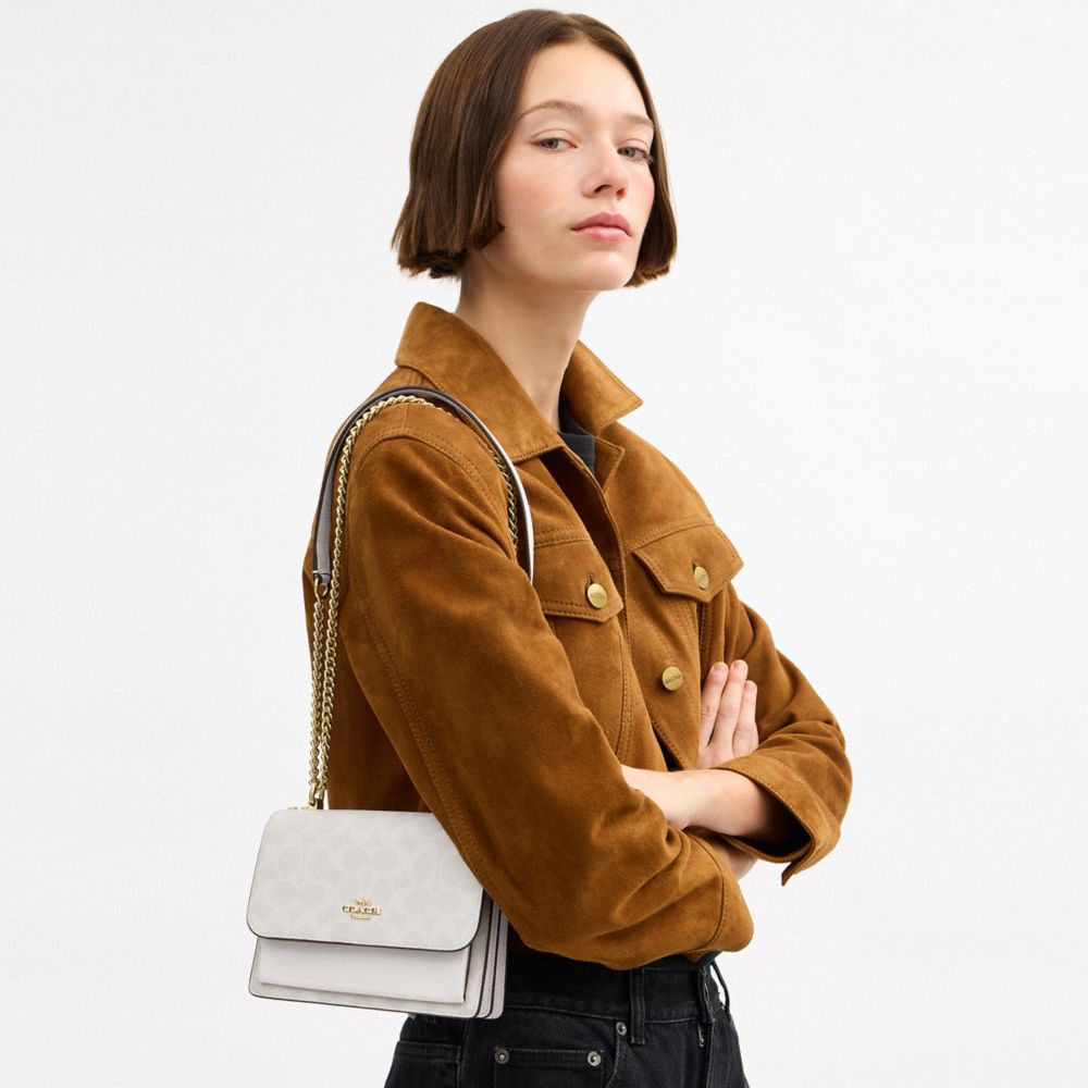 Mini Klare Crossbody Bag In Signature Canvas (Gold/White/Chalk)