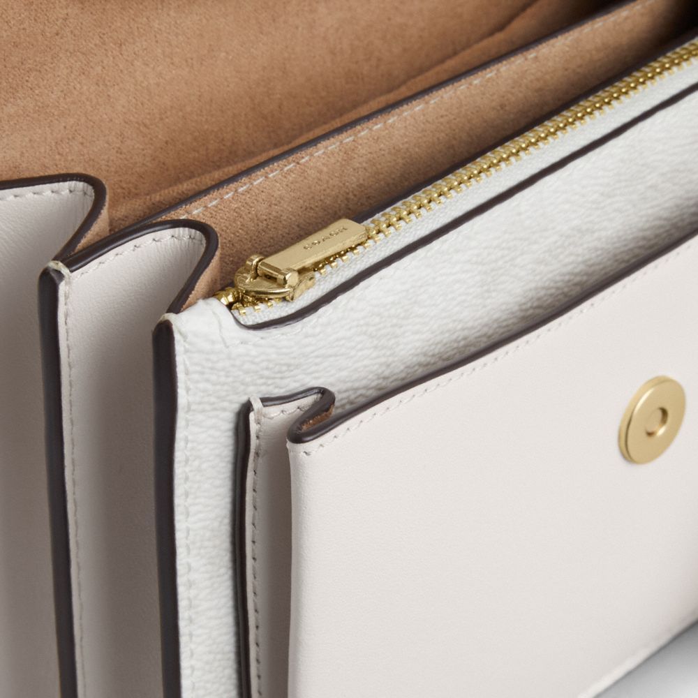 Mini Klare Crossbody Bag In Signature Canvas (Gold/White/Chalk)